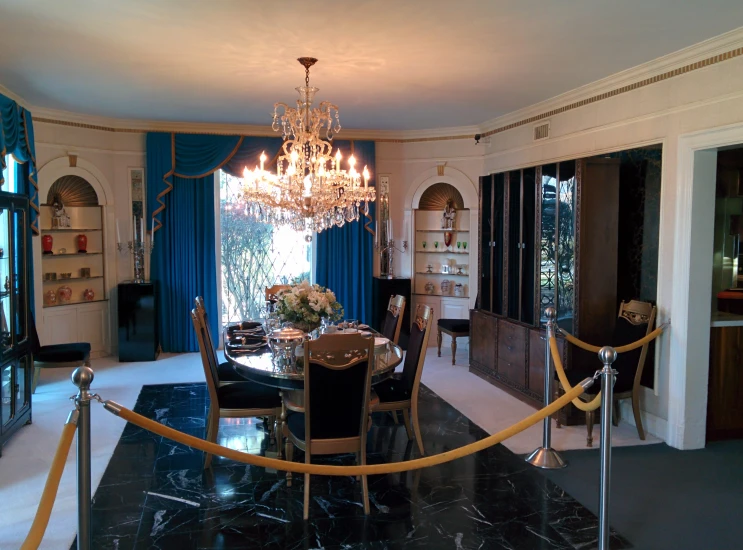 a large black dining table with some chairs