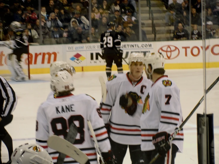 the team is getting ready to take a picture at an ice hockey game