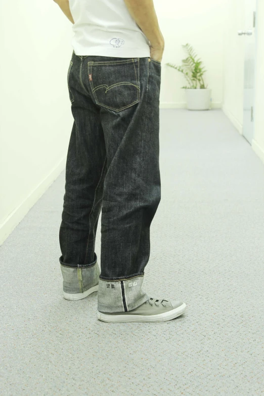 man looking down at himself in his jeans
