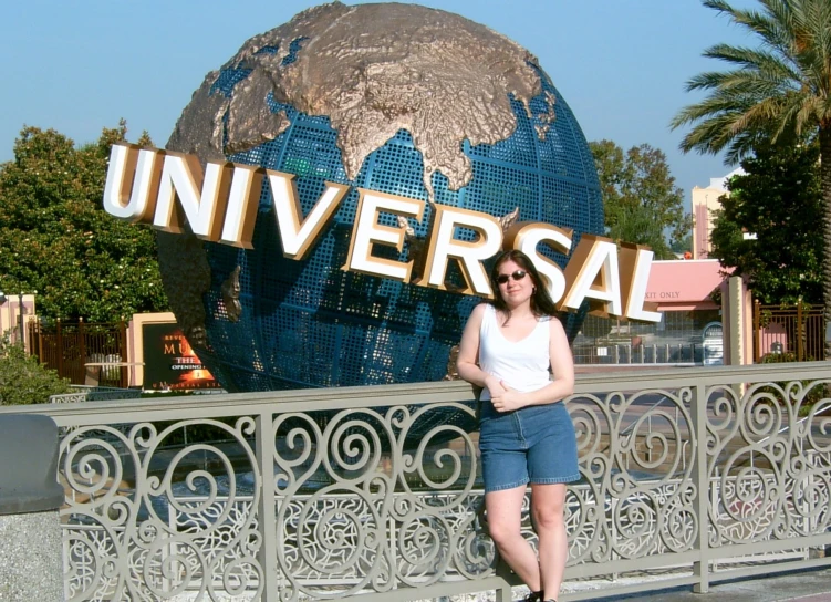 a woman poses for a po in front of universal hollywood