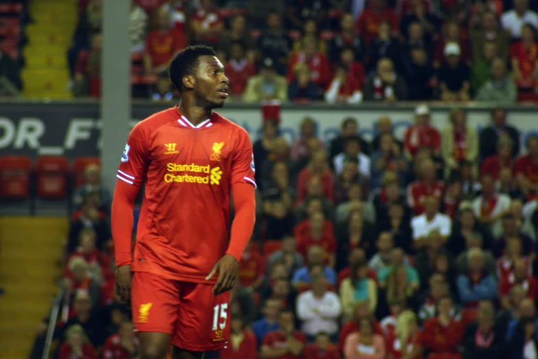 a person wearing a red shirt walking on the field