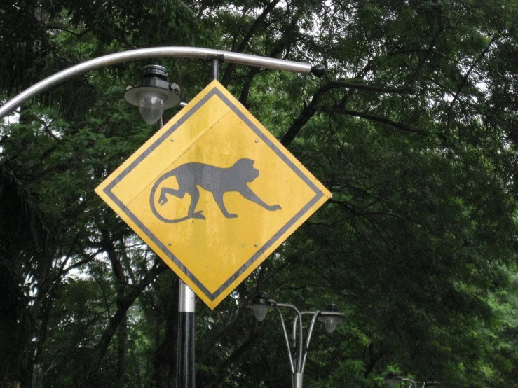 an upside down sign of a stylized monkey crossing the street