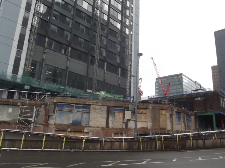 there is an old, abandoned building and a very tall building