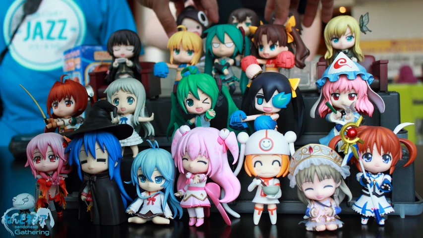 many cute anime figurines are sitting on a table