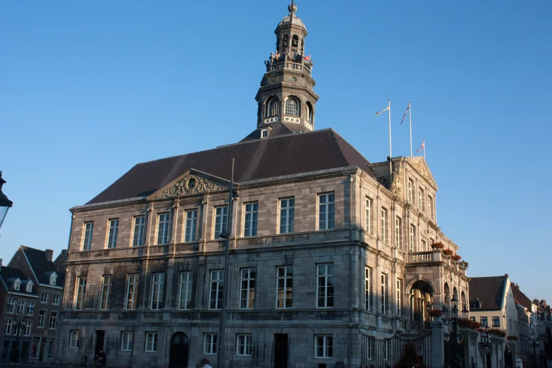 the building has many windows with a clock at the top