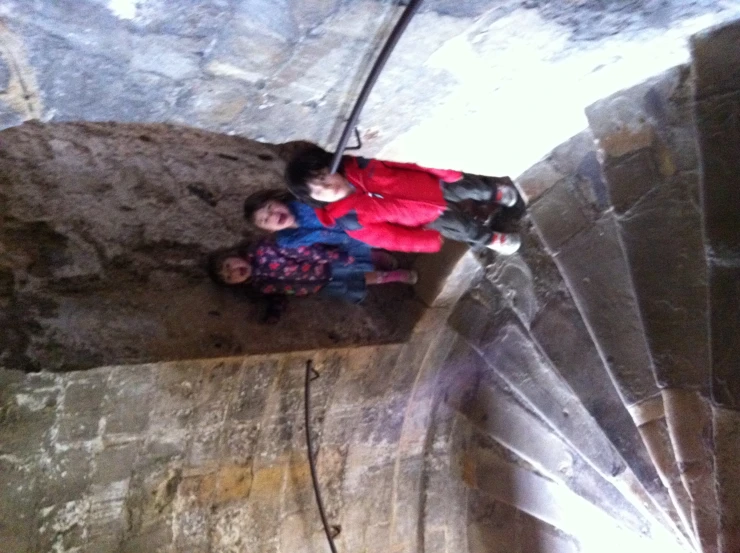 two little children on a stair case with their backpacks