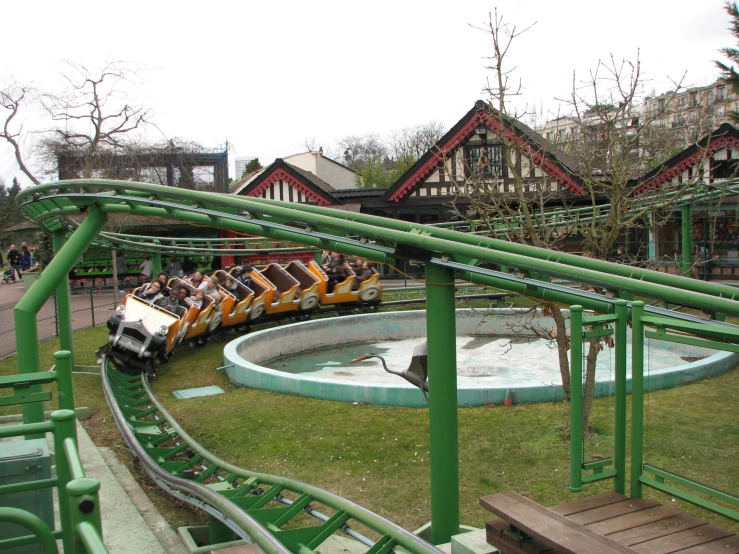 an amut park with green colored rails and a train