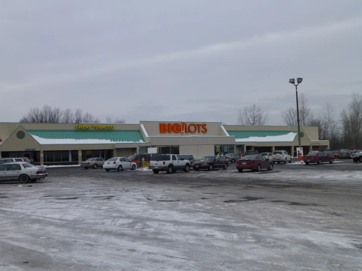 the storefront of an empty, snowy parking lot