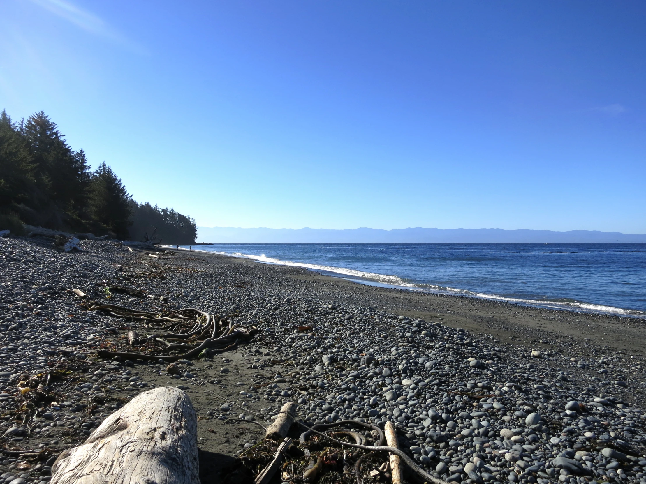 the shoreline of the sea near a large lake