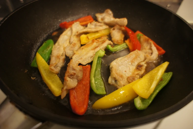 a black pan filled with cut up bell peppers