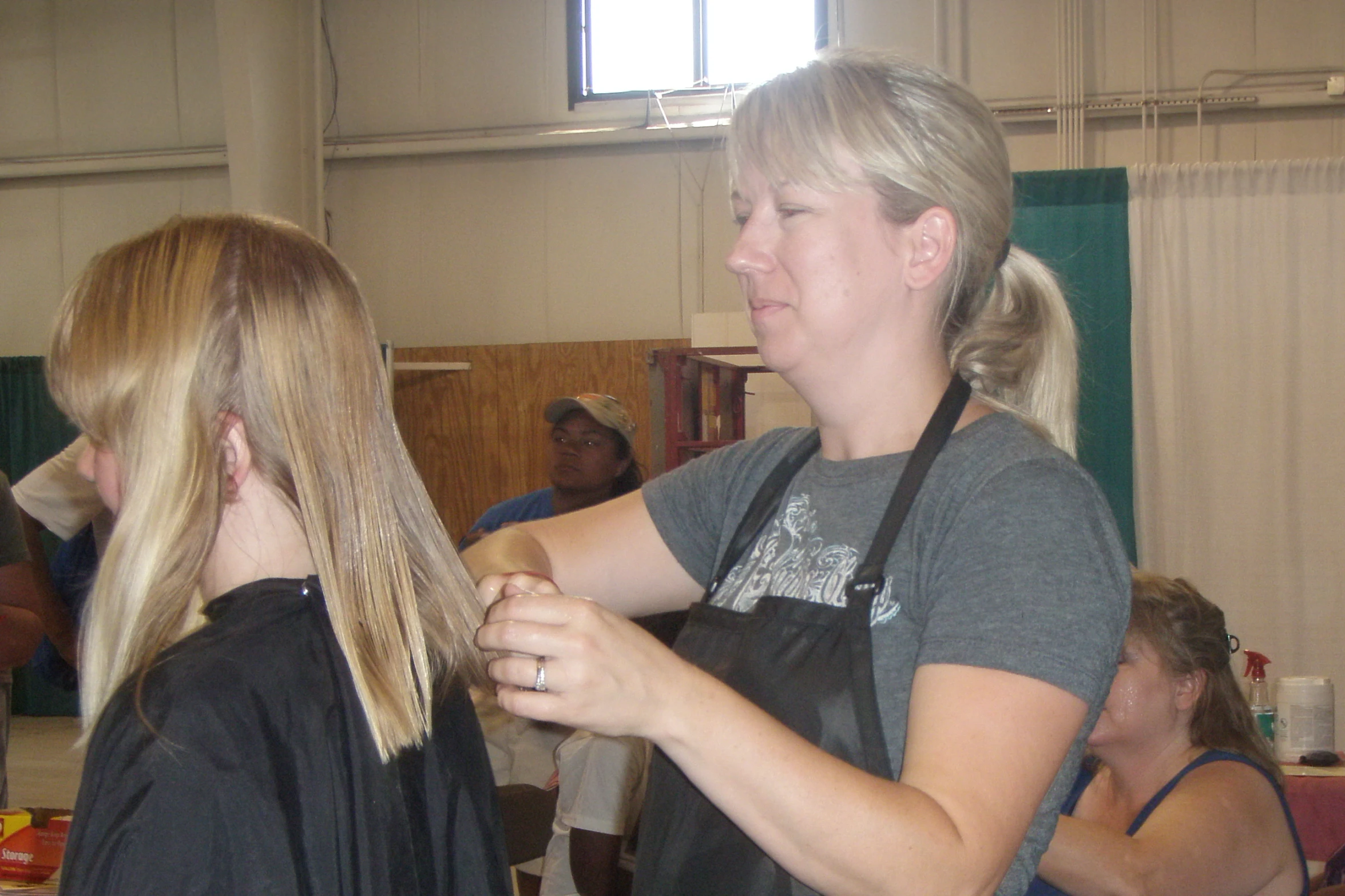 a lady getting her hair brushed and combed