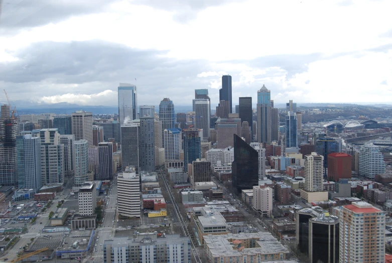 a cloudy view of a city with lots of tall buildings