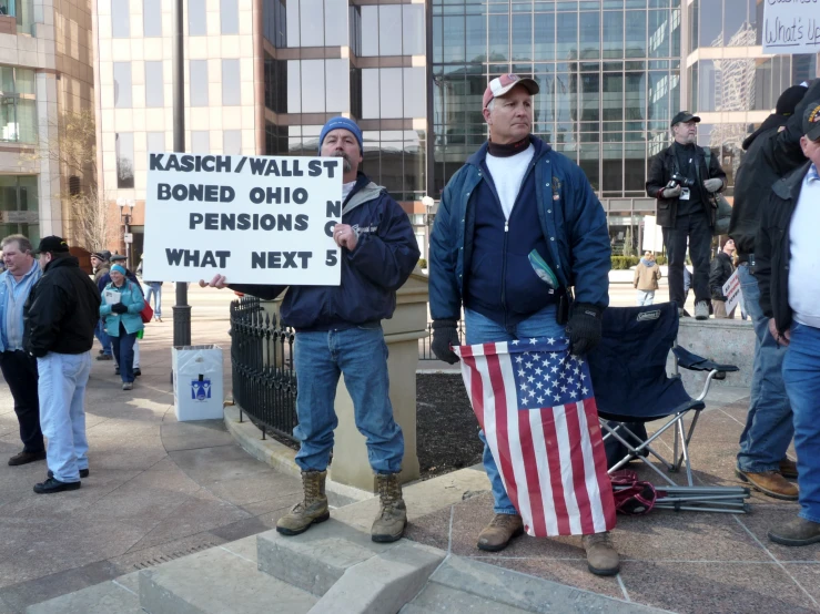 a man is holding up a protest sign