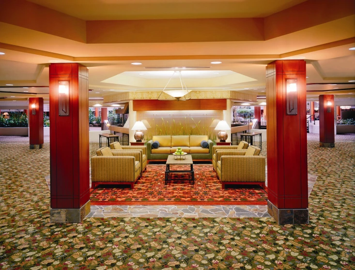 the lobby has two couches and chairs, and carpeted floor