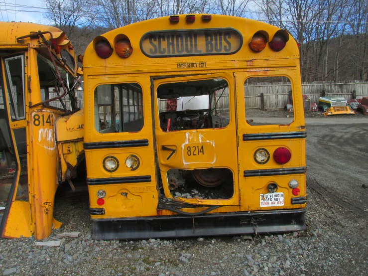 an old, yellow school bus is in the lot