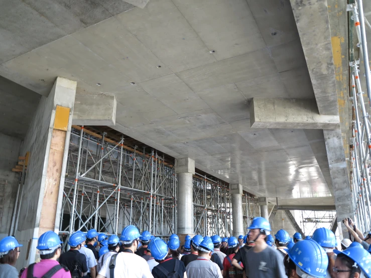 a group of people standing around a construction area