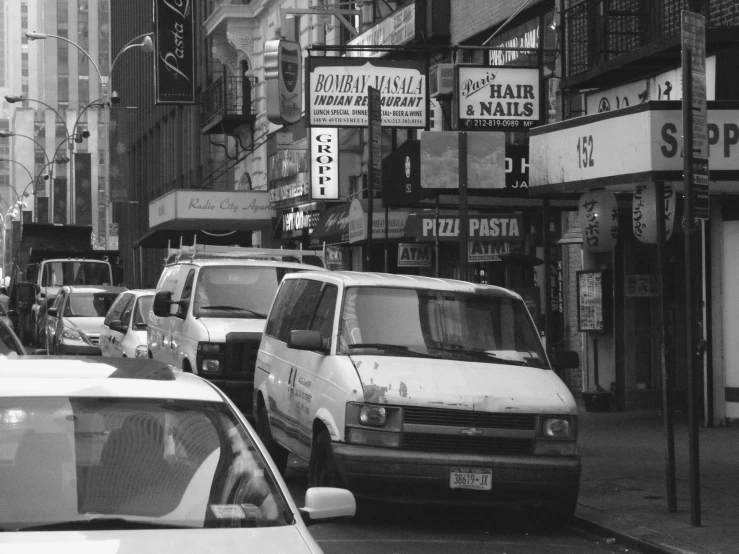 cars and buildings in the city are shown in this black and white pograph