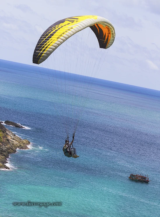 a parasailer in the water being pulled by a boat