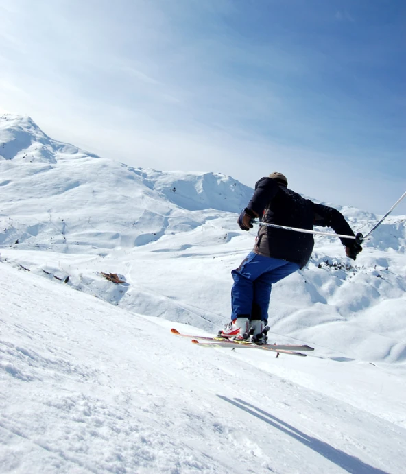 a man flying through the air while riding skis