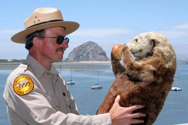 a man dressed like a groundhog wearing a sheriff uniform