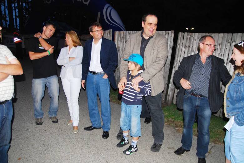 a group of people are outside with candles