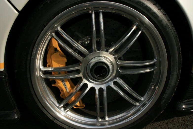 a wheel on a white car parked at night