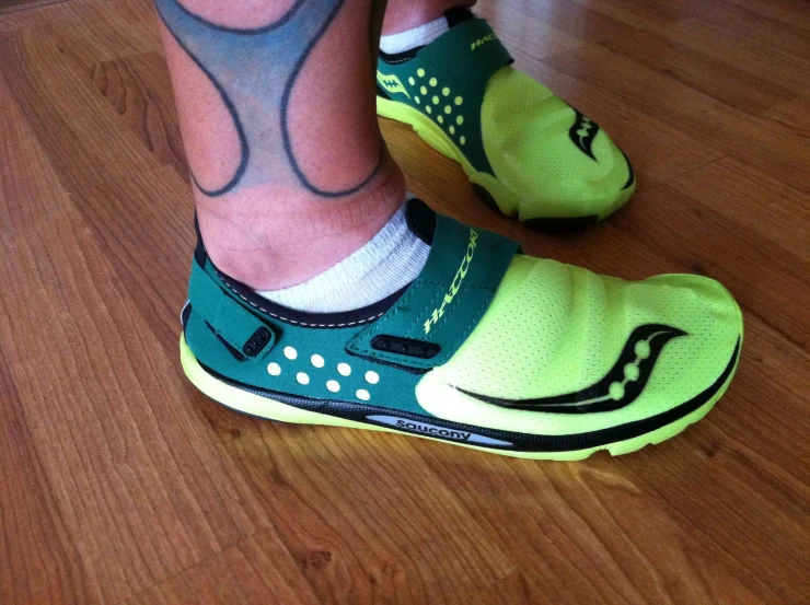 a man with colorful socks and green sneakers