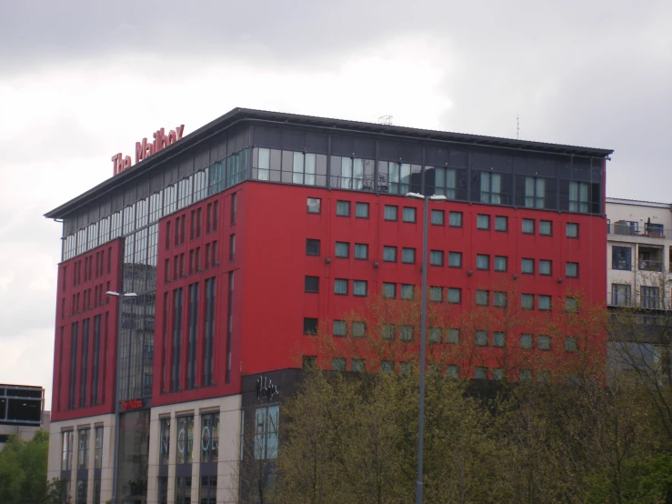 a large red building with several stories on it