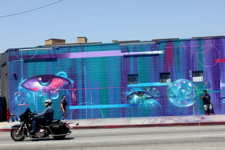 a motorcycle with a man on the back on a street