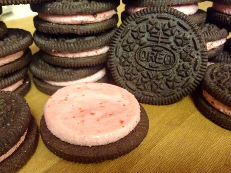 several large cookies and a chocolate sandwich with a red frosting