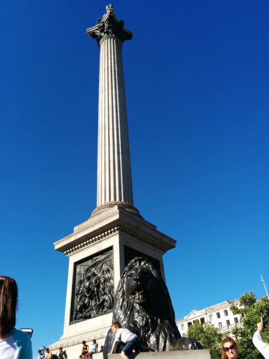 people are standing next to a monument