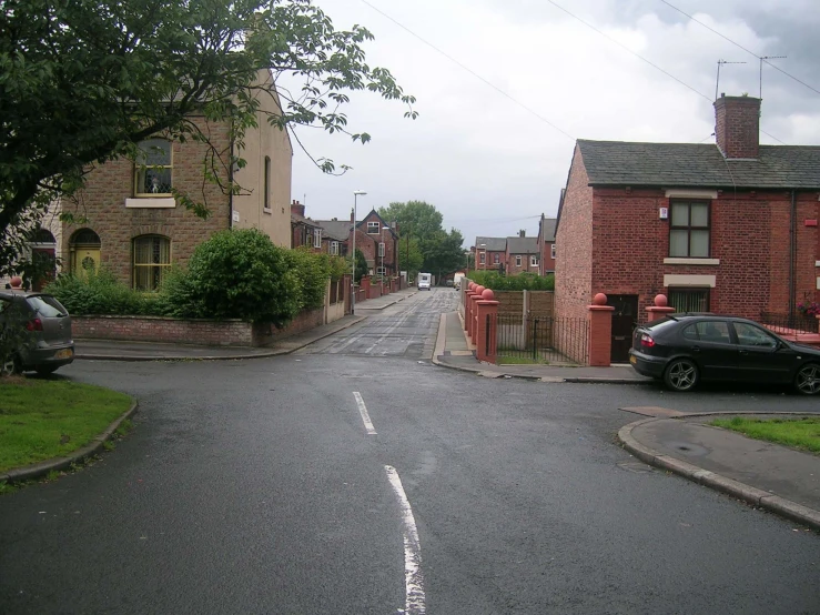 a narrow residential street with red brick buildings