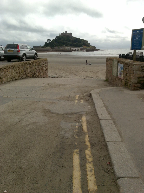 cars parked on a parking lot next to an island