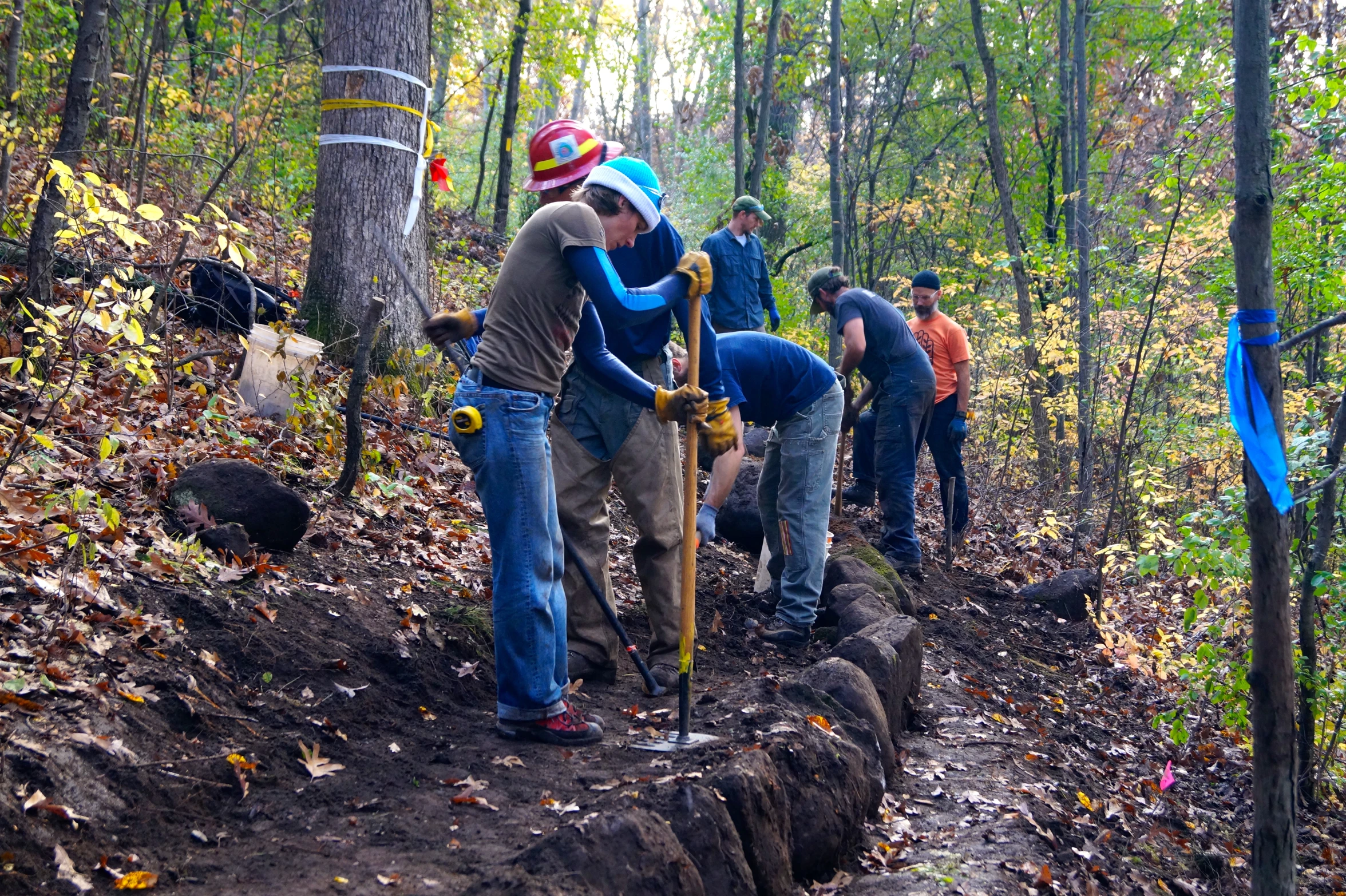 a group of people stand on some dirt