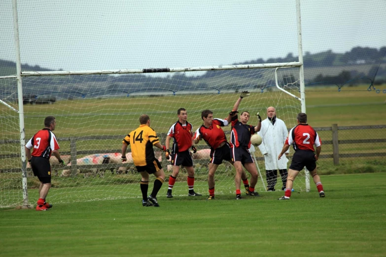 people standing around in front of a soccer net