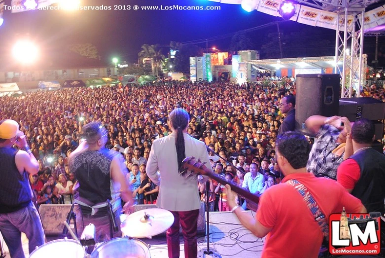 band members perform at the festival for a large crowd