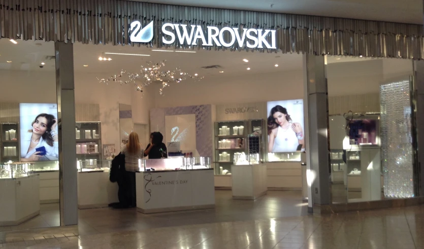 a woman looking into a store window in front of its display