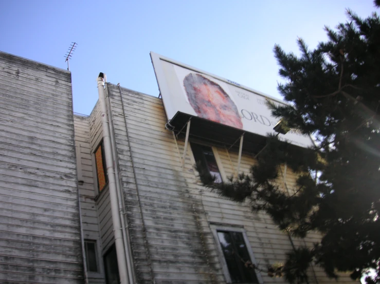 a man standing on the side of a white building