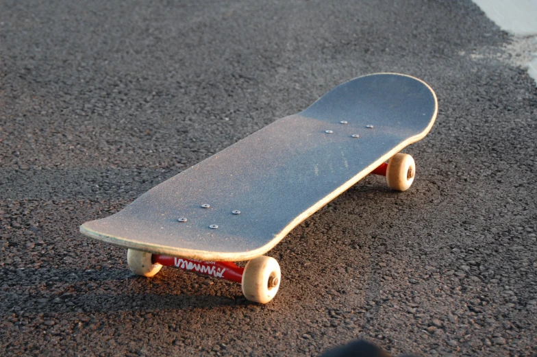 a skate board on the ground near gravel