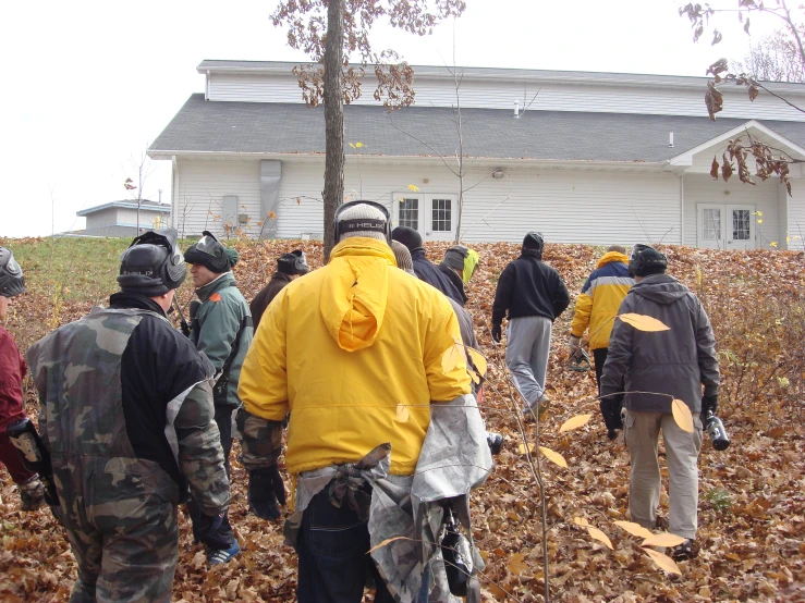 a group of people that are standing in the leaves