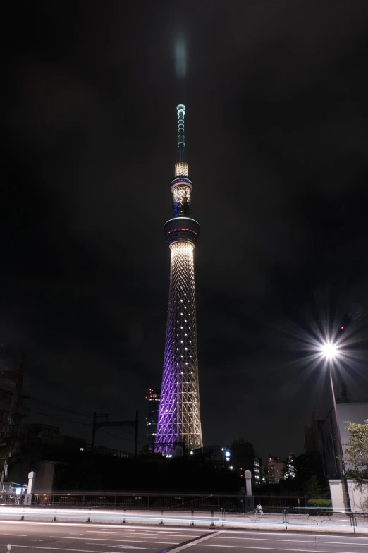 a view of the tokyo tv tower lit up in blue and white