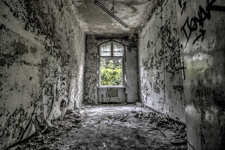 a dark, abandoned hallway with crumbling walls and windows