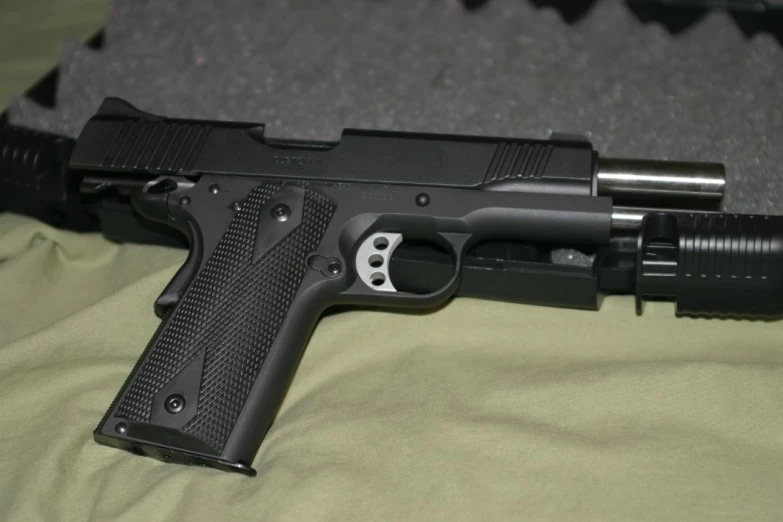 a colt handgun sits next to a gun, its magazines in the back