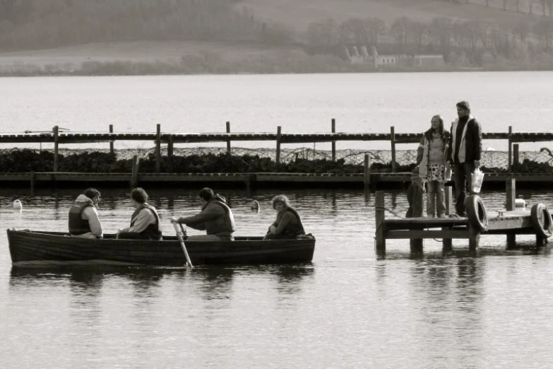 people in boats with lifejackets on the water