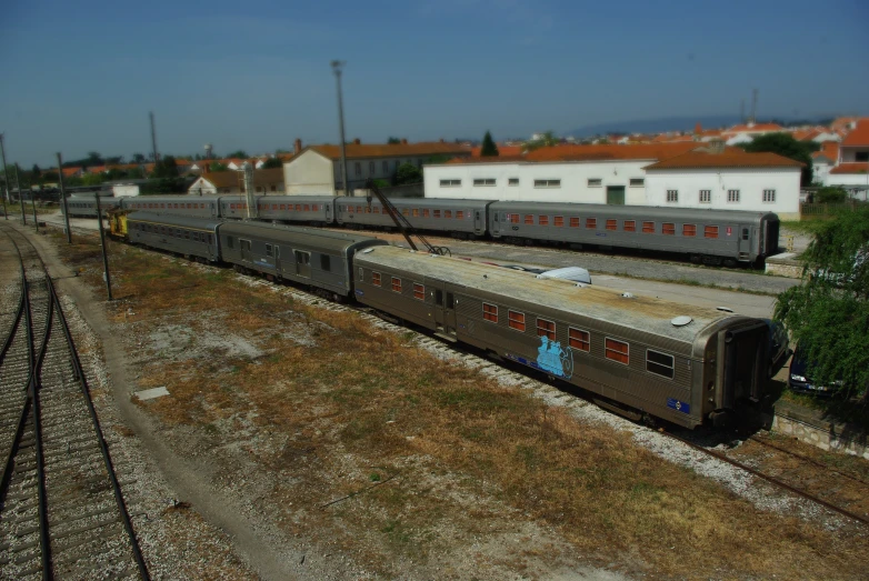 two trains with graffiti on them traveling along the tracks