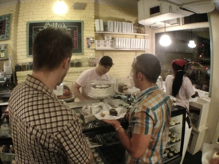 several people are preparing a meal in a restaurant