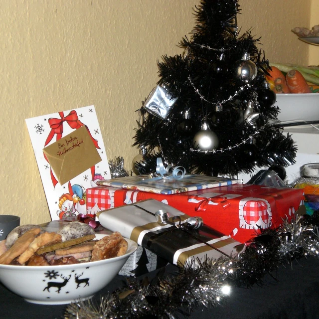 a christmas tree sitting next to a bowl of cookies