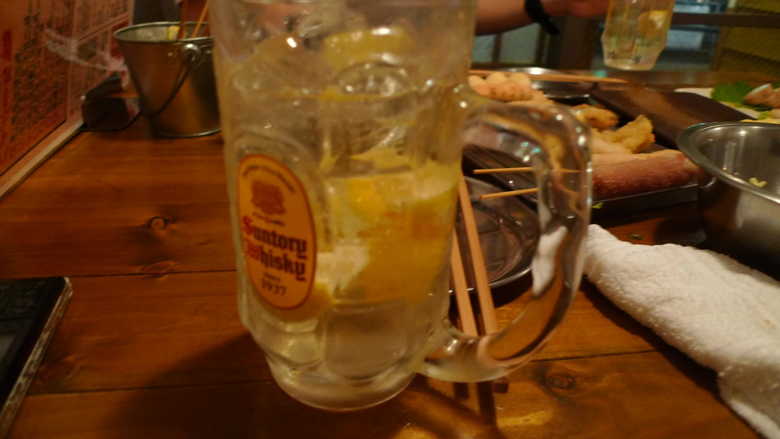 the pitcher of water is full of ice and lemon wedges