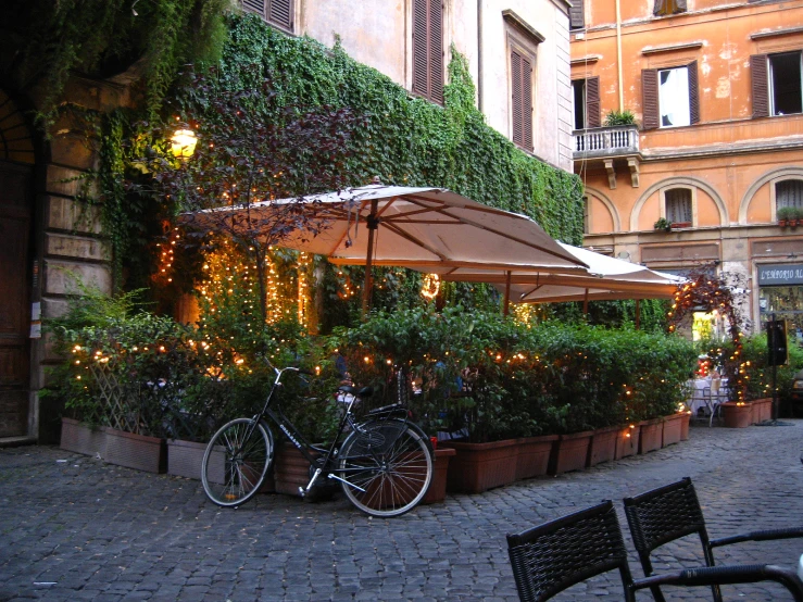 bicycles are parked in the courtyard of a restaurant