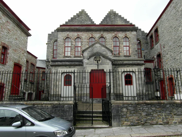 a car parked in front of a stone building